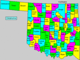 Multicolored map of cities counties in Oklahoma state for out of state travelers.